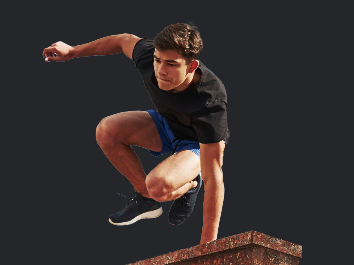Mann springt über Mauer